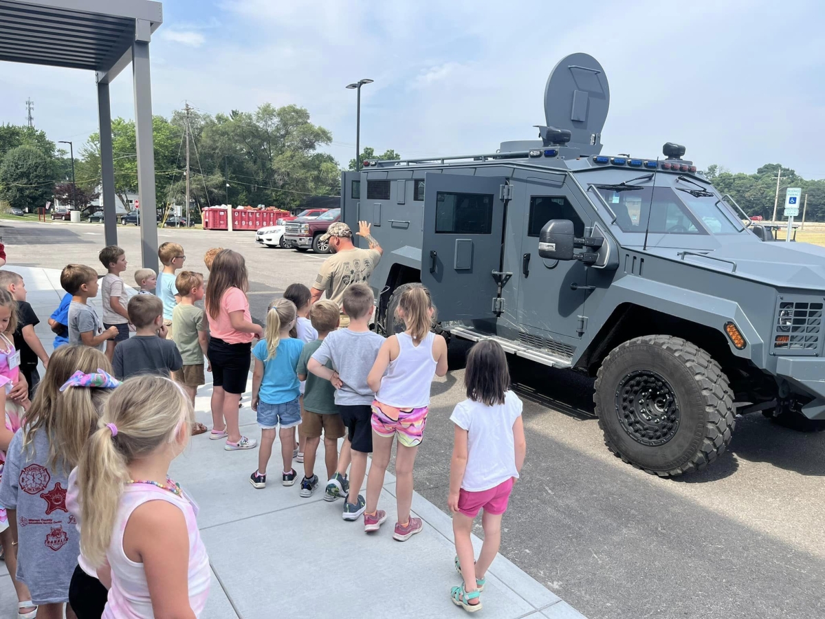 Children at Safety Town by a SWAT vehicle